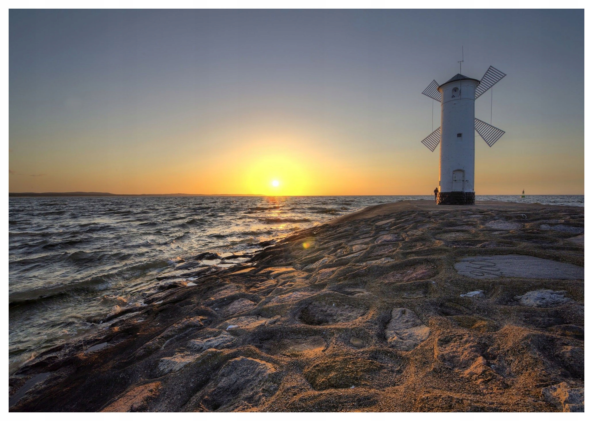 Fototapeta Západ slunce moře skalnatý břeh větrný mlýn relaxace 312x219 lepidlo