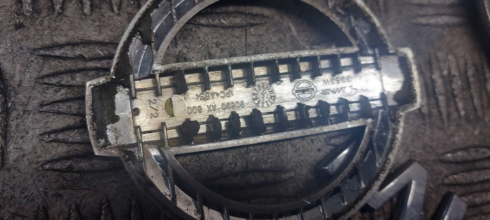 EMBLEMAT ZNACZEK LOGO GRILL KLAPY MASKI MICRA K12 90890AX600 Marka Nissan