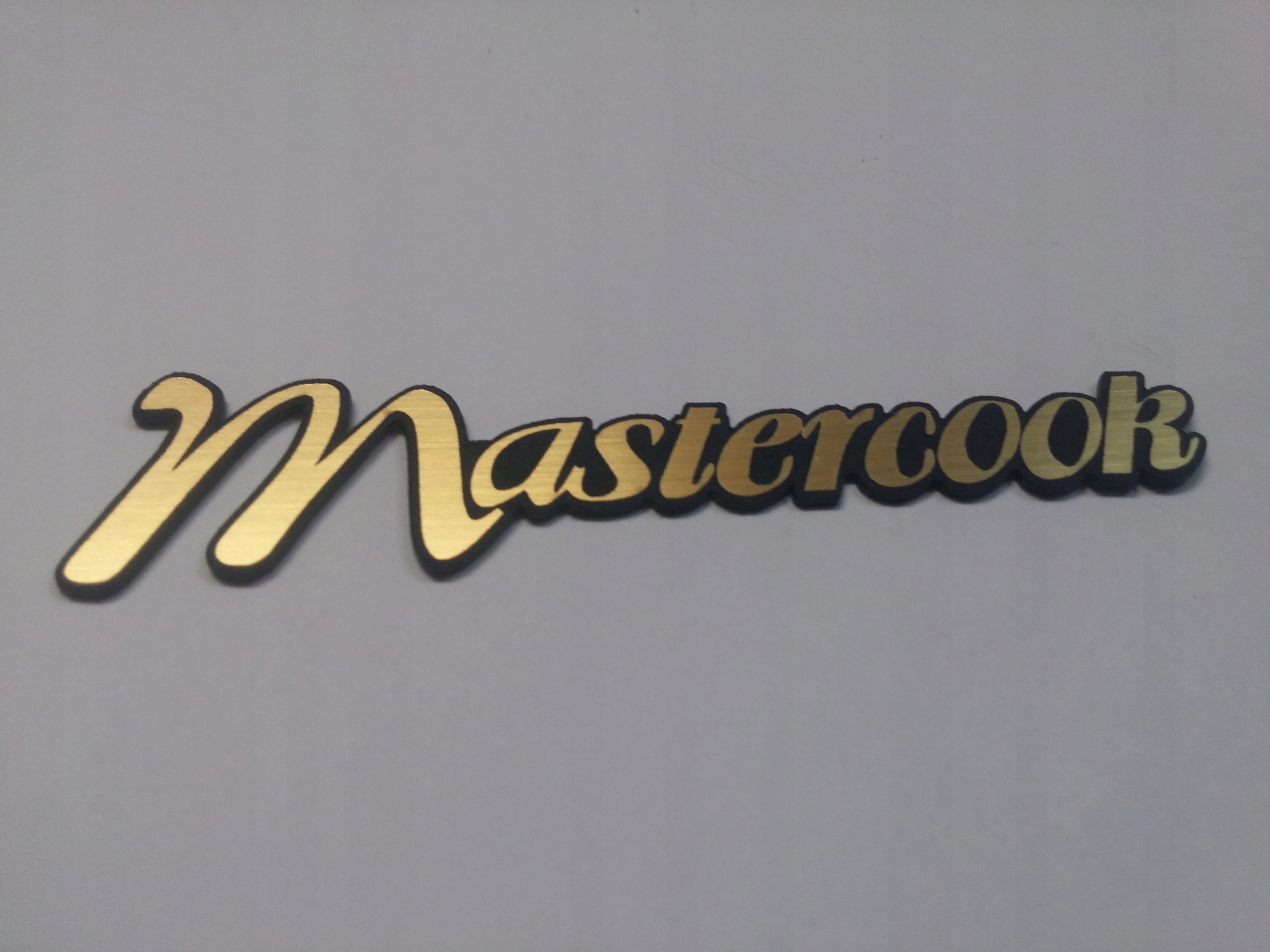 

Mastercook naklejka emblemat 82 x 20 mm *złota