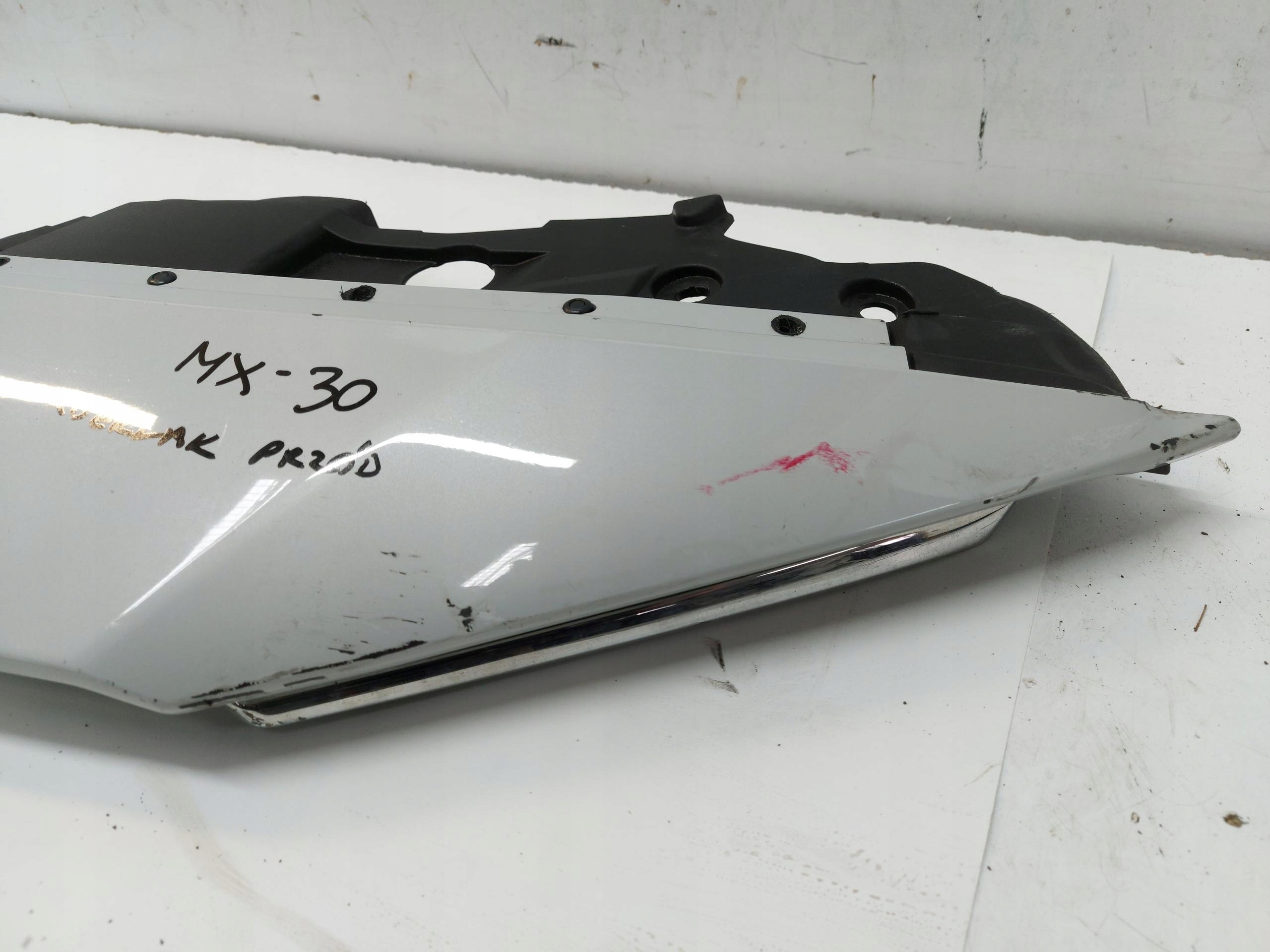 Mazda MX-30 EL cover cap upper visor of a bumper front damaged.