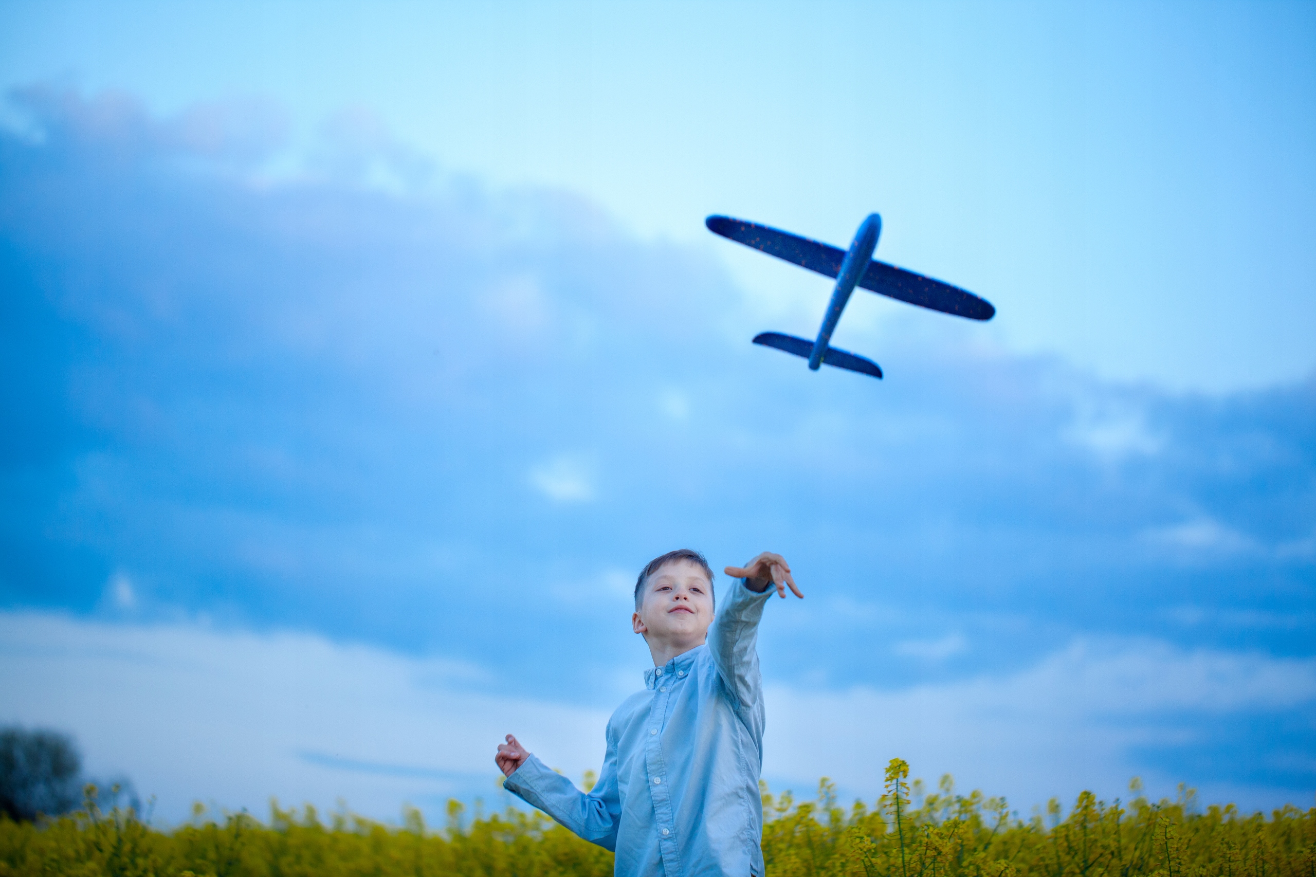 Самолет кидать. Мальчик с самолетиком. Ребенок с бумажным самолетиком. Самолет для детей. Мальчик с бумажным самолетиком.