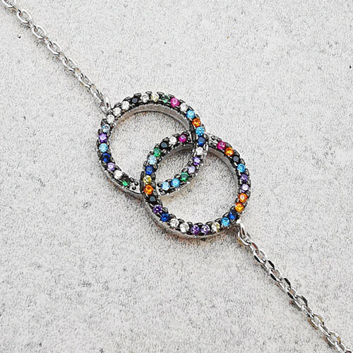 Stříbrný náramek se zirkony propletené kruhy