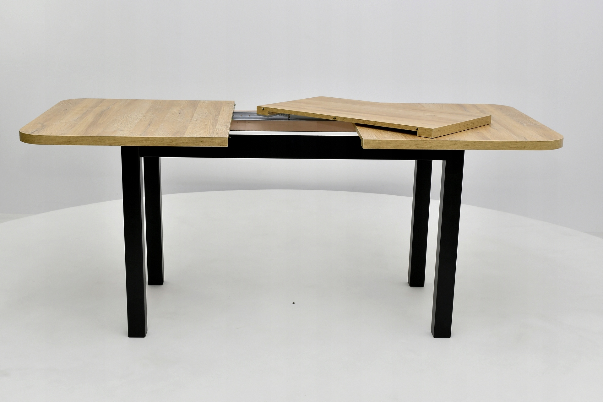 rozkładany stół, zaokrąglone rogi, blat dąb grandson, podstawa, nogi czarne Szerokość mebla 140 cm