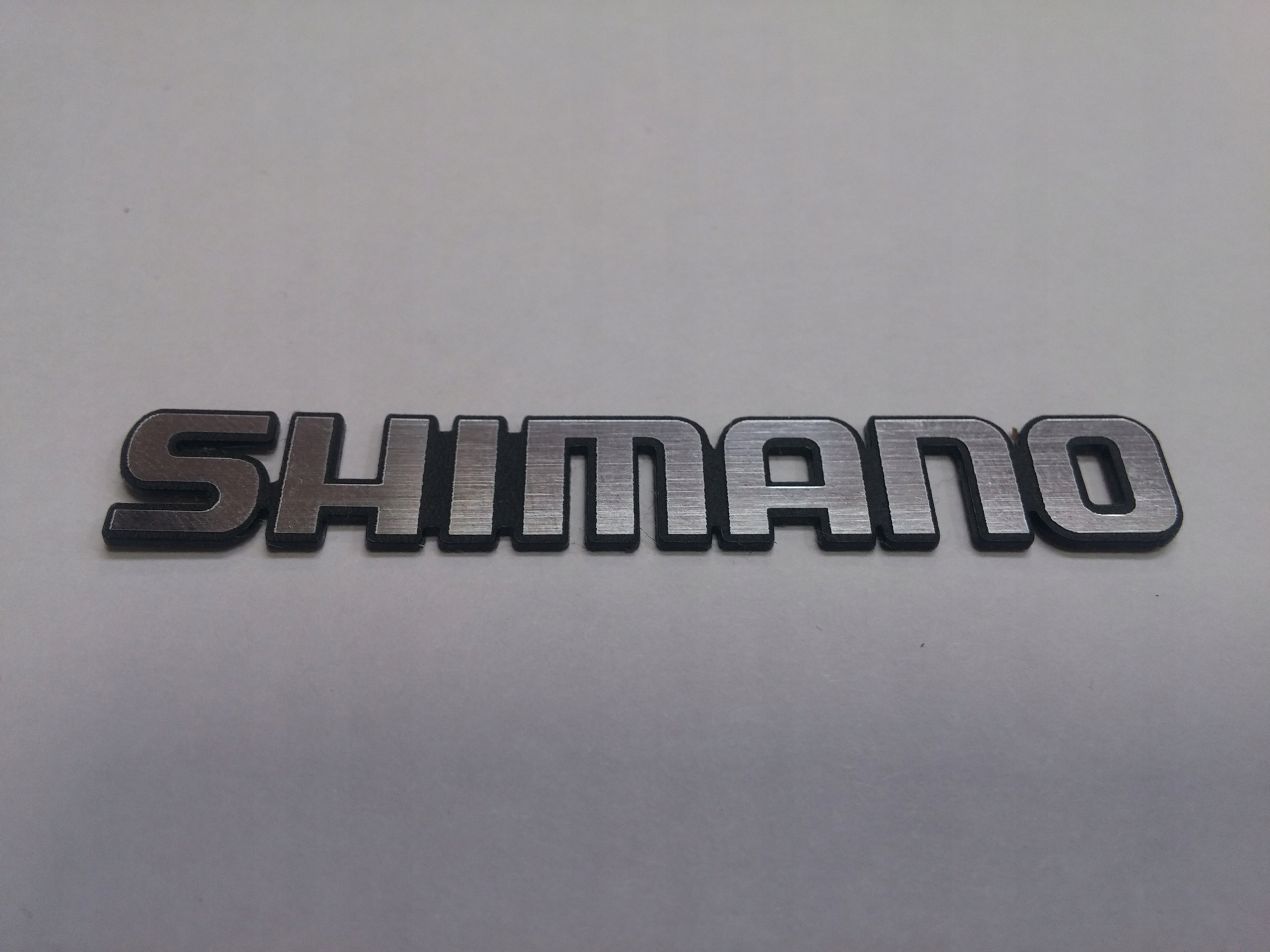 

Shimano naklejka emblemat 132 x 20 mm * Srebrna