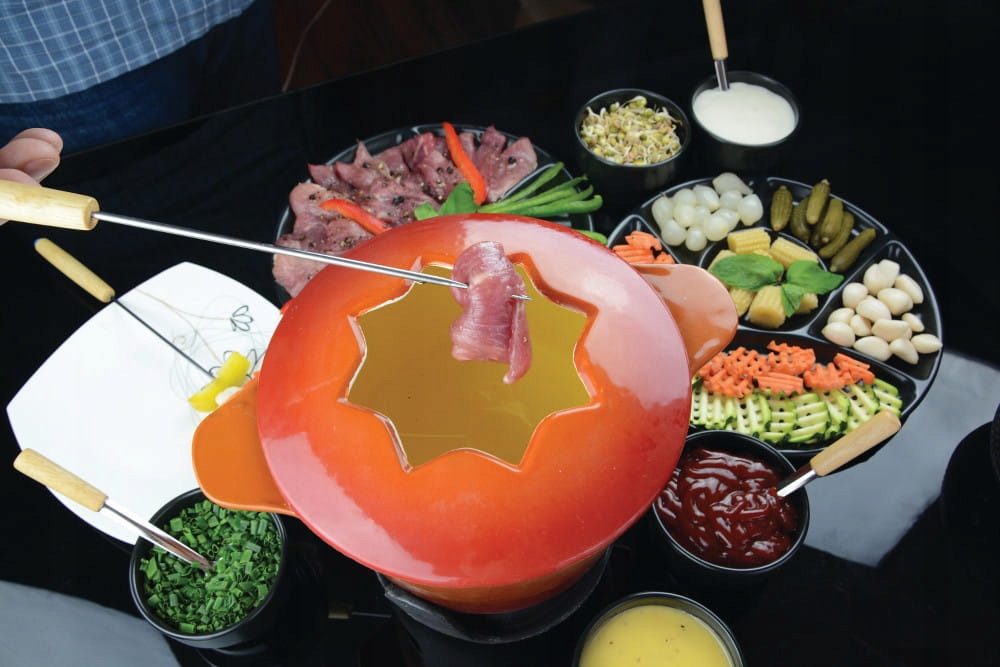 

Żeliwny zestaw do fondue pomarańczowe