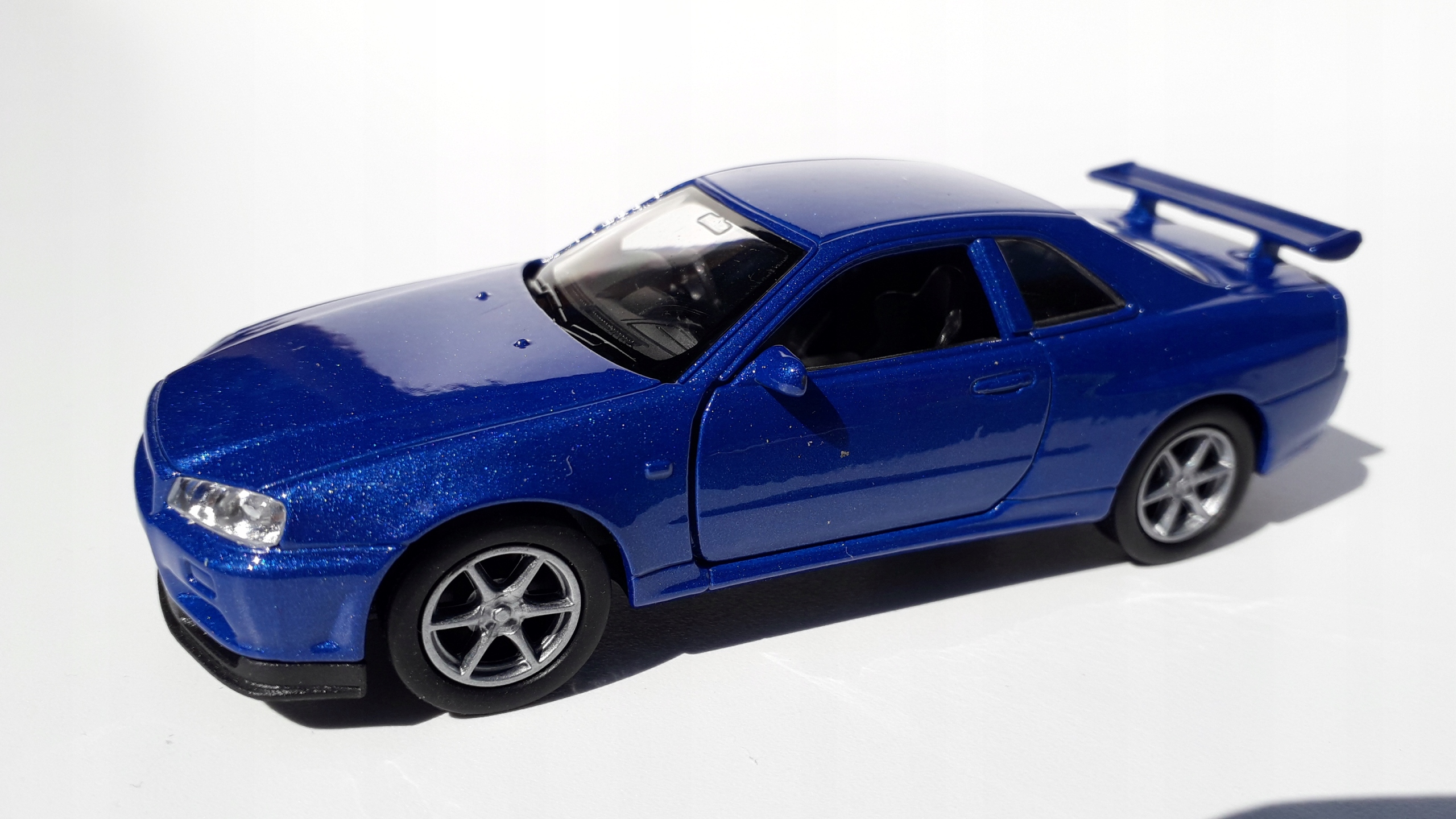 Nissan Skyline GT-R(R34) Niebieski Metalowy Model WELLY 1:34 Wiek dziecka 3 lata +