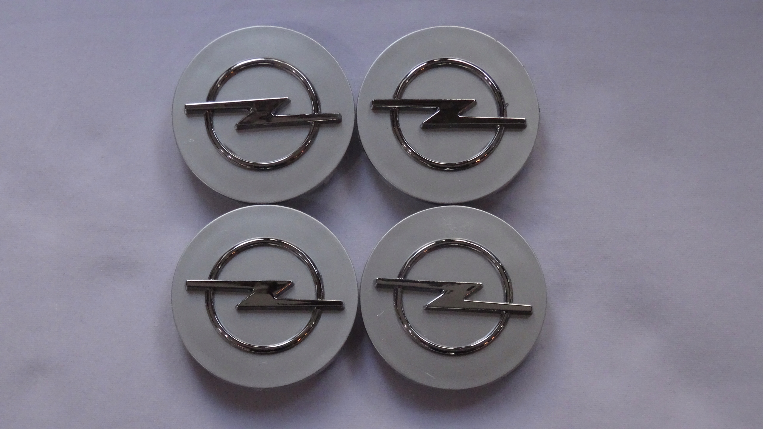 

4x Dekielki Dekle na felgi Opel 64 mm 3D srebrne
