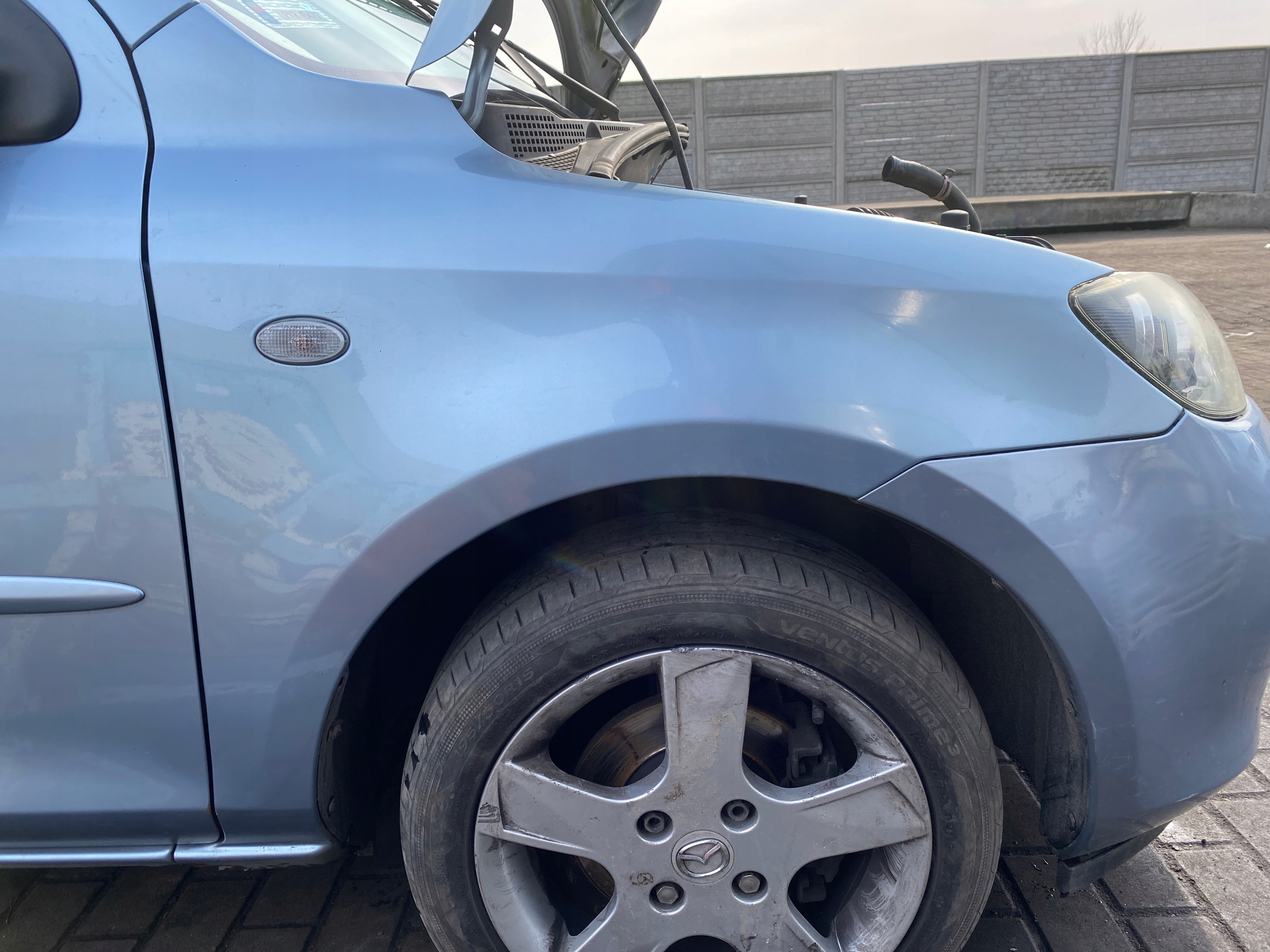 Mazda 2 1 and FL 03-07 fender right front front kod lakieru 27P