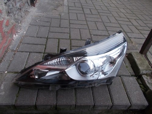 TOYOTA VERSO LIFT SOCZEWKA LEWA PRZEDNIA LAMPA ORYGINAŁ