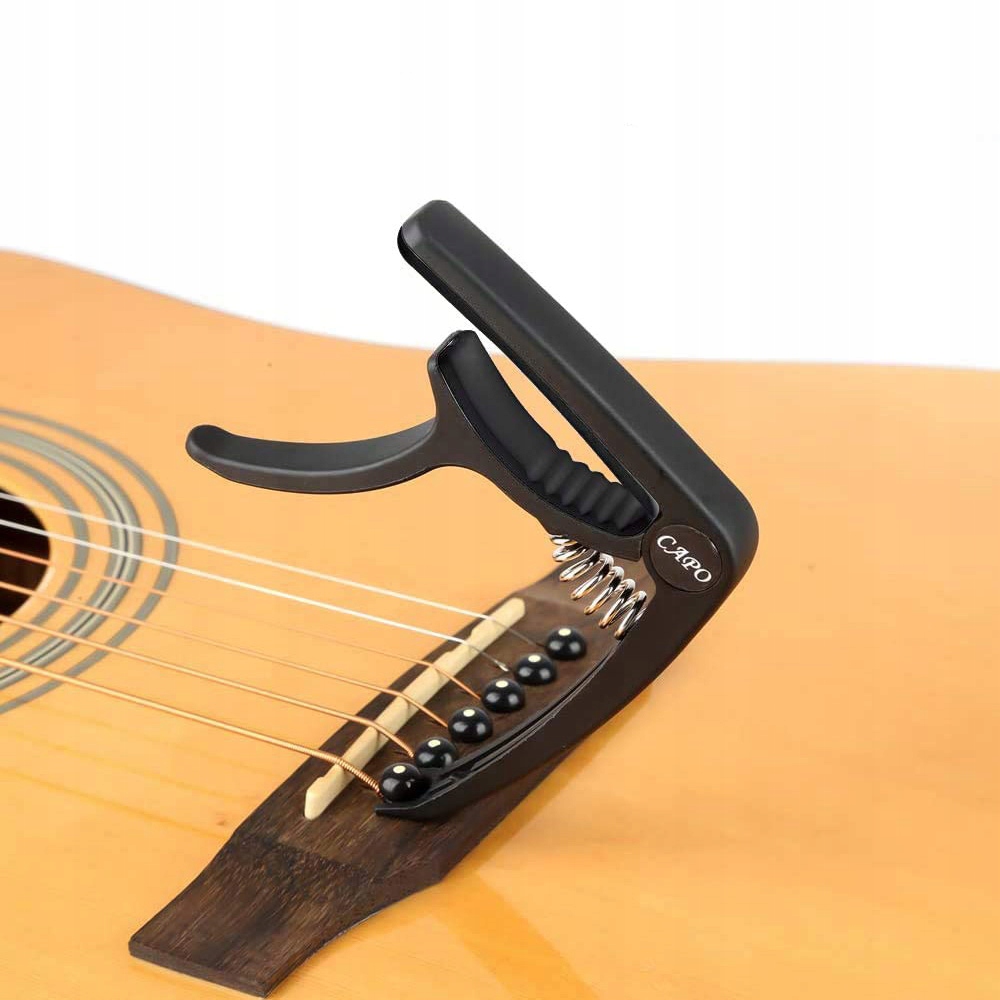 KAPODASTER CAPO DO GITARY KLASYCZNEJ AKUSTYCZNEJ NAKŁADKA NA GRYF STRUNY Stan opakowania oryginalne