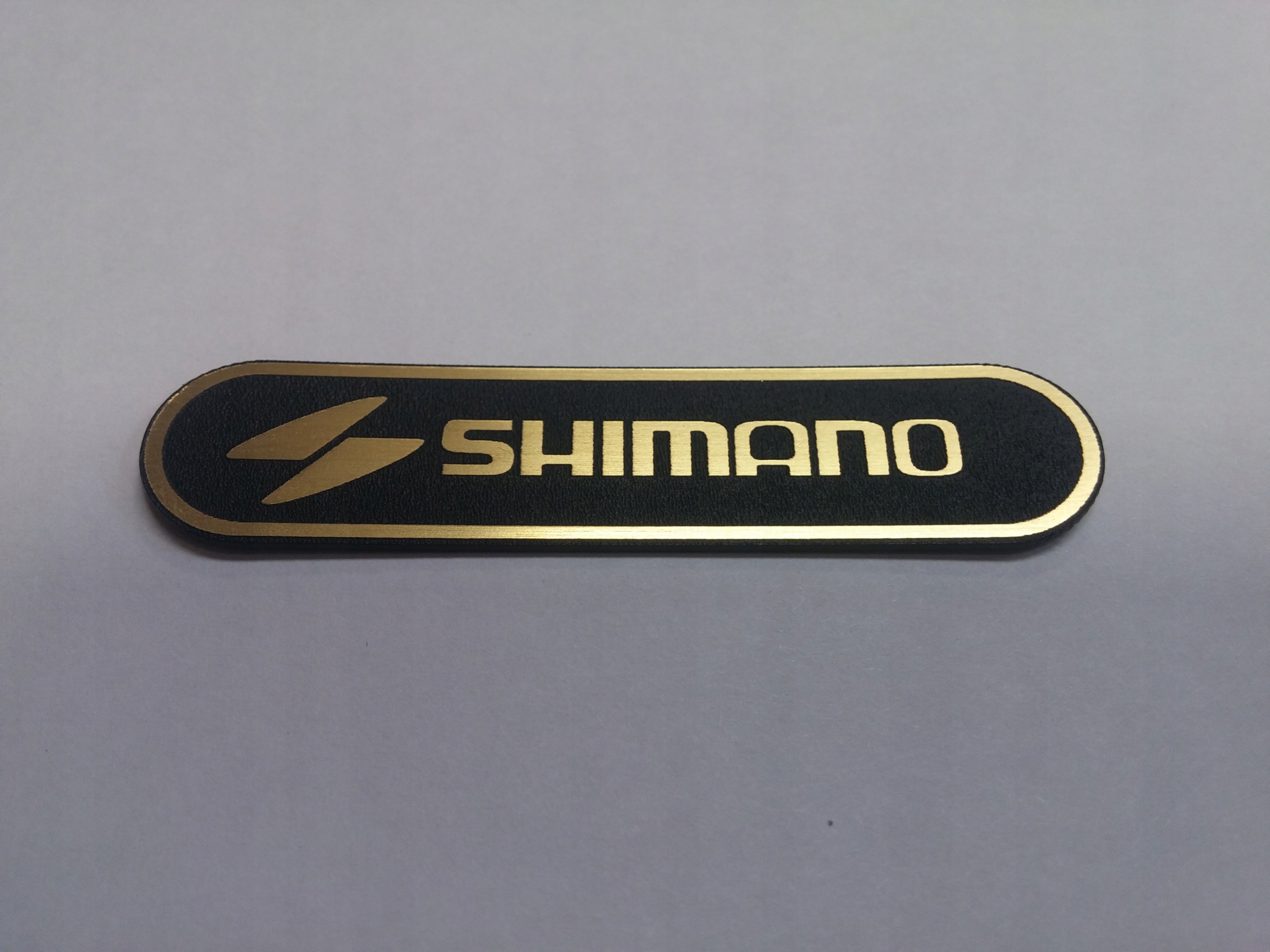

Shimano naklejka emblemat 60 x 13 mm * Złota