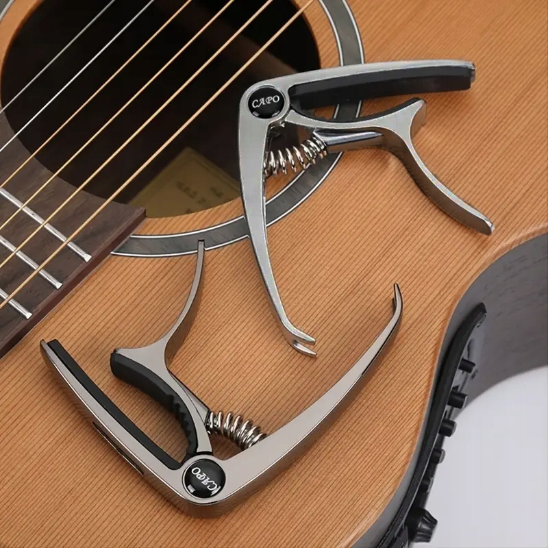 Kapodaster Capo Do Gitary, Ukulele Metalowy 3w1 + 5 SZT. KOSTKI + UCHWYT Stan opakowania oryginalne