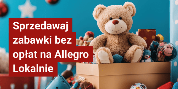Teddy bear, tan plush, sitting on a blue box, surrounded by toys.