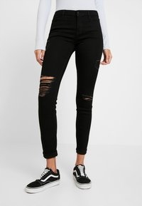 HOLLISTER czarne spodnie jeansy z dziurami skinny