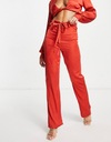 Femme Luxe červené dámske nohavice defekt 38 Dominujúci vzor bez vzoru
