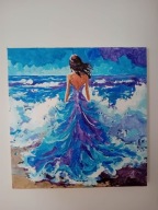 Kobieta w niebieskiej sukni na plazy