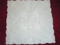 Biały, ręcznie haftowany obrusik.