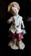 LEONARDO COLLECTION Śliczna porcelanowa figurka chłopca z winogronem