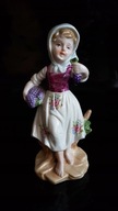 LEONARDO COLLECTION PORCELANOWA FIGURKA DZIEWCZYNKI Z WINOGRONEM