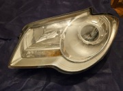 Lewa lampa Touran lift 06r Uszkodzone uchwyty do naprawy 