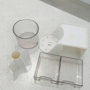 biały organizer na biurko z dwiema szufladkami i przegródkami na przybory