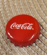 Kapsel Coca Cola butelkowane