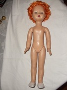 Duża nieubrana lalka kauczukowa.