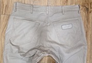 Beżowe Spodnie męskie jeans Wrangler Texas Stretch W34L34