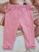 Pomarańczowe spodnie dresowe legginsy z falbanką George 62 - 68