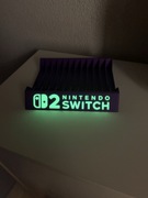 Stojak Podstawka na gry Nintendo Switch 2 napis Fluorescencyjny