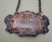 Posrebrzana pokryta patyną zawieszka na karafkę brandy art nouveau antyk