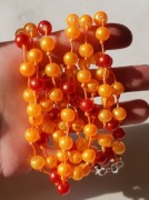 Naszyjnik krótki kaskada pomarańczowy czerwony szklany złoty pył sznurek