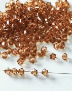 Kryształki Swarovski Bicons 4mm Light Smoke Topaz - 75szt
