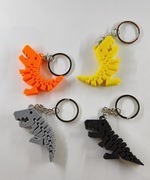 Urocze, słodkie breloczki motyw dinozaur trex