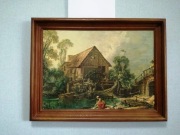 Reprodukcja obrazu.Kobieta pierze pranie w strumieniu obok młyna wodnego.