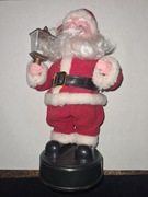 Tańczący grający śpiewajacy Święty Mikołaj machający lampionem 