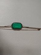 Broszka vintage z zielonym oczkiem.