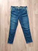 Niebieskie bawełniane jeansy z żółtym lampasem cecil 33 L/XL