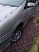 NISSAN ALMERA TINO BŁOTNIK PRZEDNI LEWY