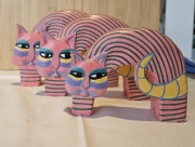 Trzy różowo-zielone drewniane figurki kotów z Bali 