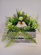 Stroik w skrzynce z parą ptaszków. Rękodzieło