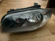 Lewy reflektor bmw e87 ciemny srodek