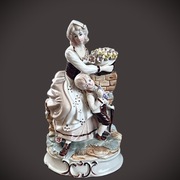 Porcelanowa figurka  Kobieta z koszykiem kwiatów i chłopiec z chlebem 