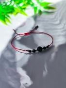 Bransoletka ochronna - czarny turmalin, czerwony sznurek, stal chirurgiczna