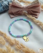 Bransoletka z masy perłowej ze złotą zawieszką kotkiem ze stali szlachetnej