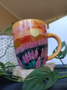 Kubek ręcznie malowany z krajobrazem zachód słońca 