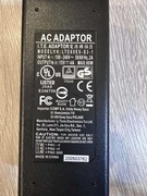 Zasilacz do drukarki fiskalnej Elzab Mera wraz z przewodem zasilającym.