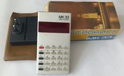 Kalkulator MK 33 wraz z ładowarką do baterii z okresu PRL-u 