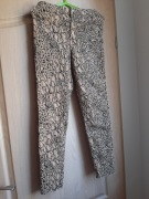 Divided - Dziewczęce spodnie w kolorze beżowym z czarnym wzorem