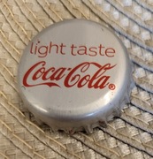 Kapsel Coca-Cola butelkowane